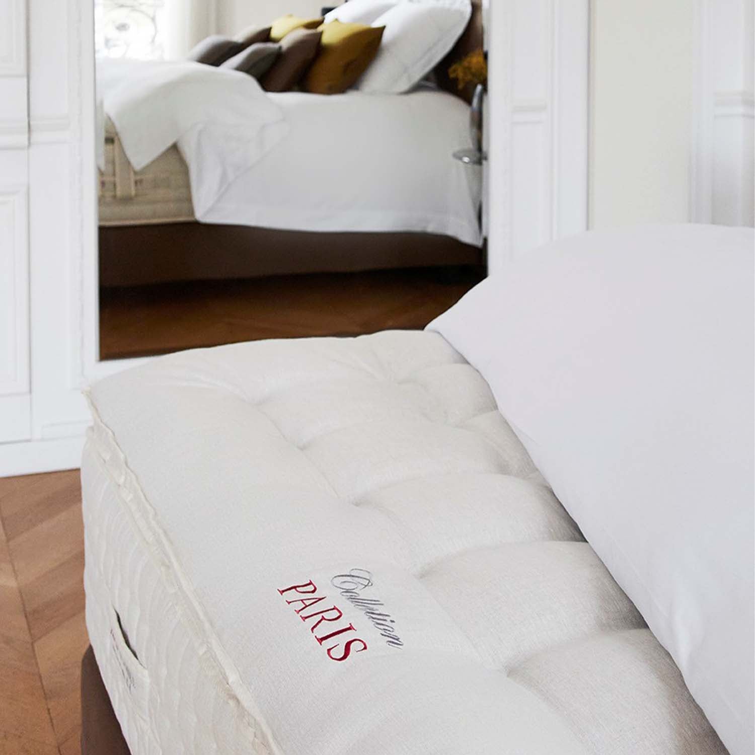 Mattress with Treca Paris topper branding in a bedroom setting