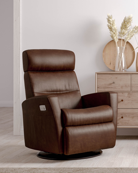quarter view of an IMG comfort divani recliner in a room with a wooden dresser and decorative items.