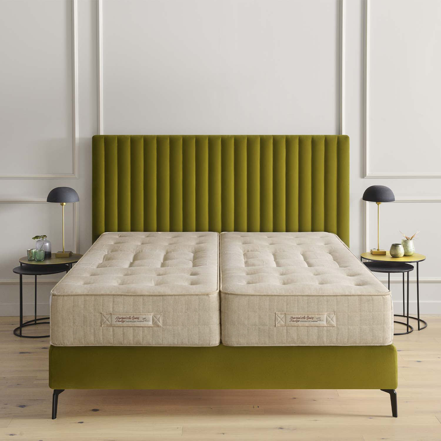 Two Treca Imperiale Air Spring Prestige on a green bed frame in a room with white walls and wooden flooring.