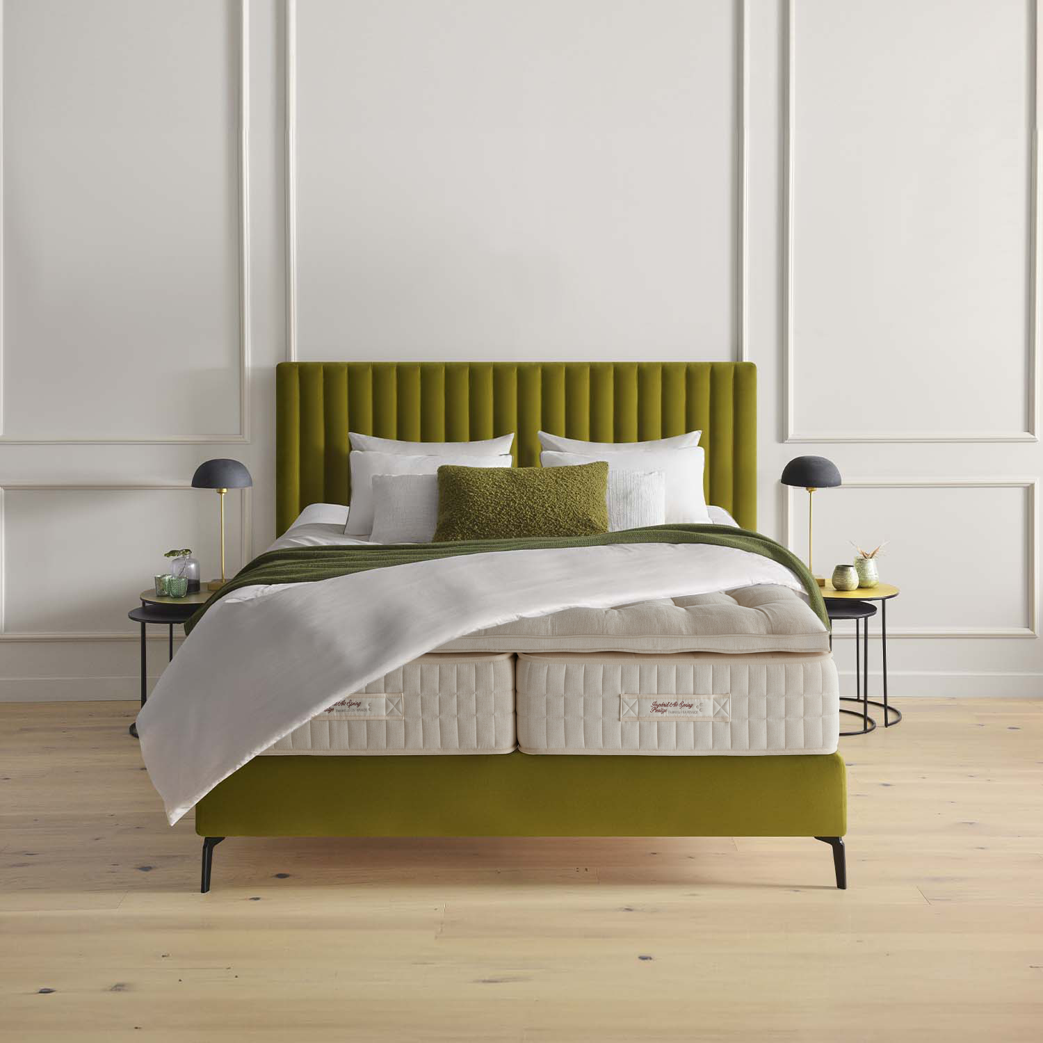 Green bed with a Treca Imperiale Air Spring Prestige in a minimalistic bedroom setting